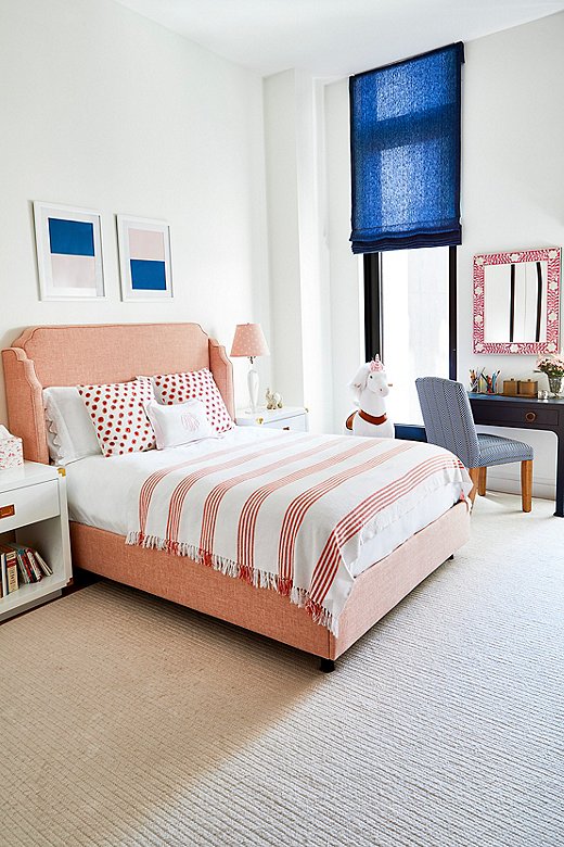 “We let the kids have a say in their own rooms—a place where they would be happy sleeping, studying, and playing,” Ashley says. This bedroom includes the Kos Raffia Console in Navy as a desk. Find the side chair here and the mirror here.
